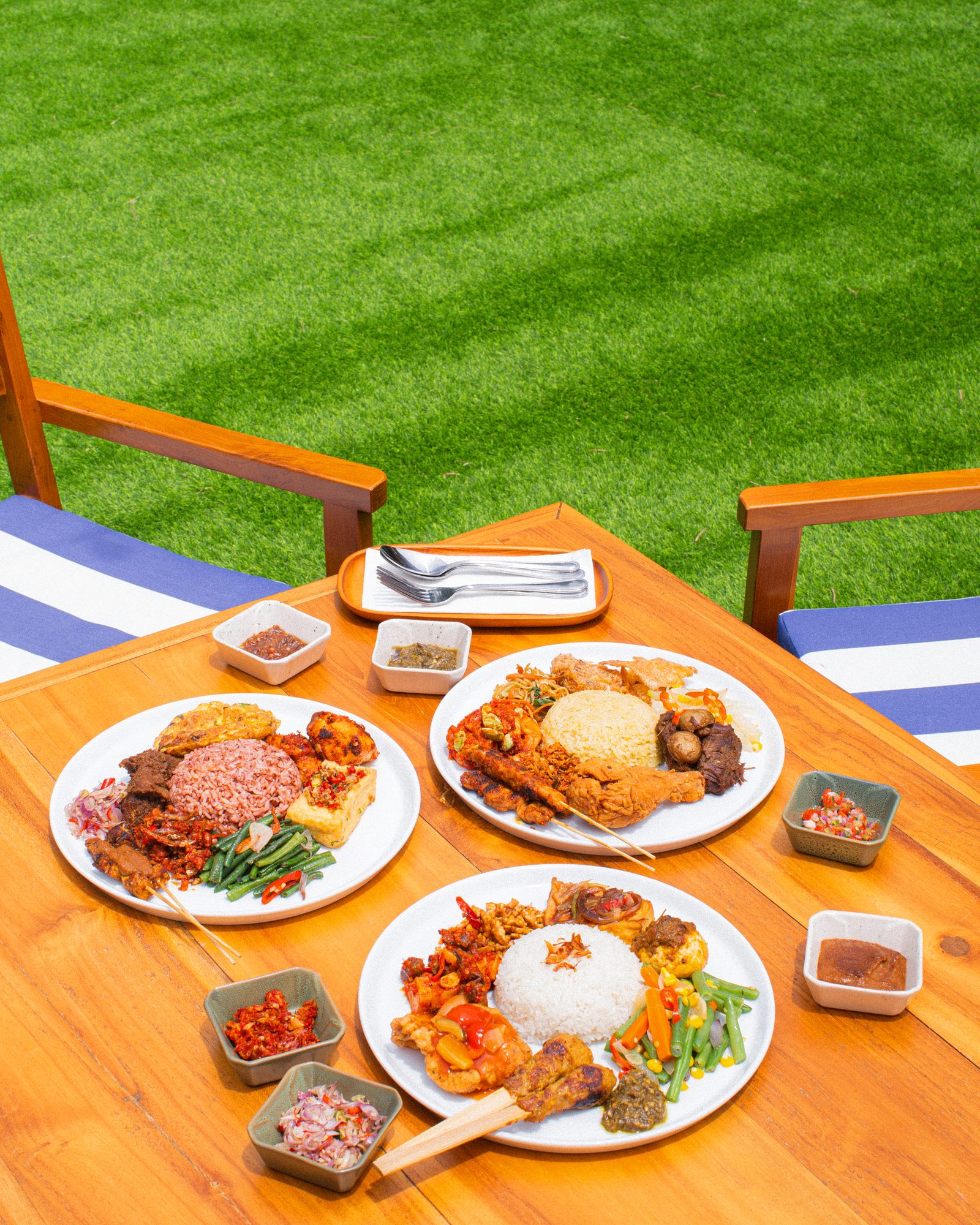 Nusantara plates — rendang, sate lilit, sambal — at a Bali warung