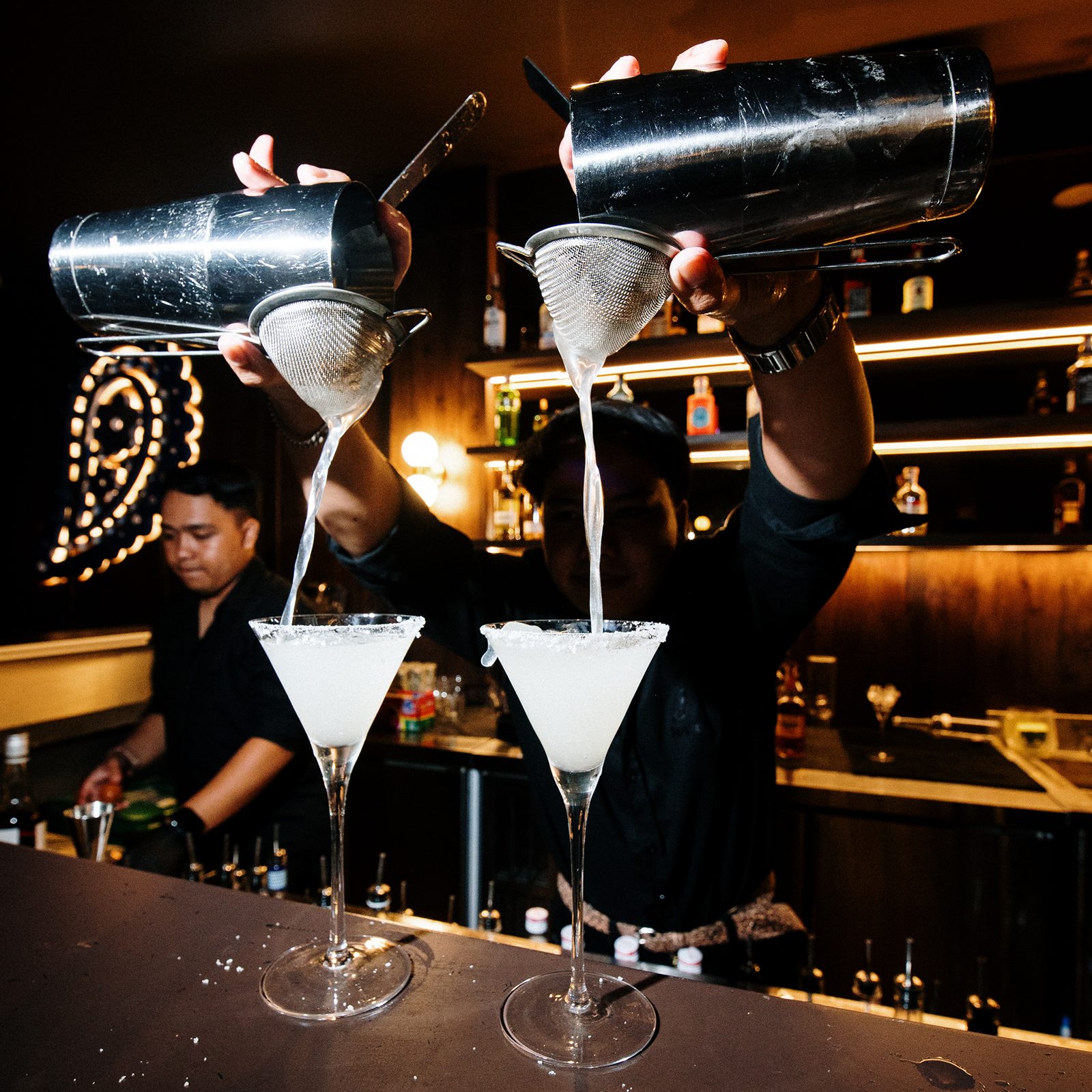 Bartenders straining cocktails at Paisley, Berawa